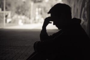 upset man with major depressive disorder sits alone