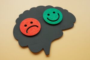 concept of bipolar disorder with happy and sad faces