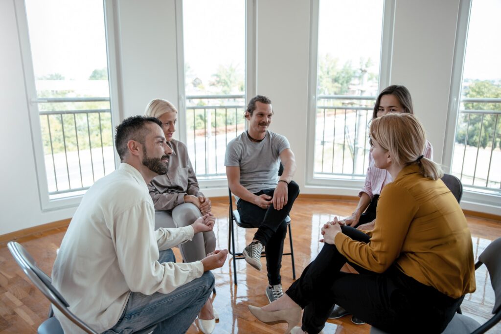 inpatient vs oupatient treatment options - a group therapy session in progress
